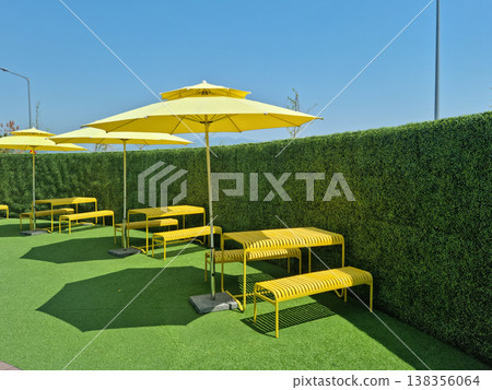 It is an outdoor cafe with parasols. 138356064