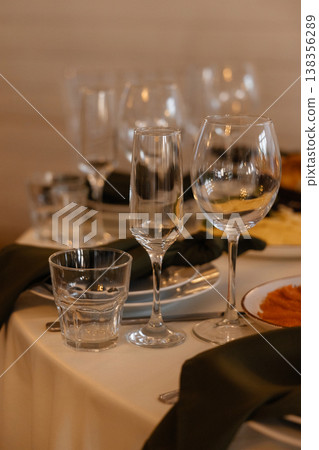 Chic Setup Of Beverage Glasses And Linens Illuminated Softly For Elegant Celebration Chic Setup Of Beverage Glasses And Linens Illuminated Softly For Elegant Celebration 138356289