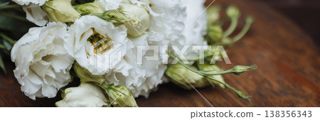 Banner White lisianthus bouquet lying on wooden table with dark wooden background and copy space 138356343