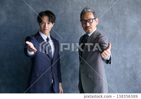 Japanese men line up and extend their hands Japanese men line up and extend their hands 138356389