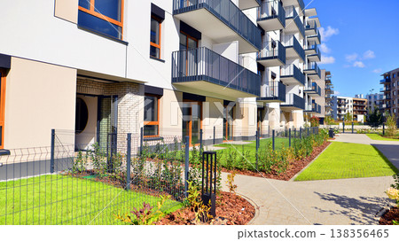 The garden of a modern residential building with a green lawn and a place to relax. Home garden. The garden of a modern residential building with a green lawn and a place to relax. Home garden. 138356465