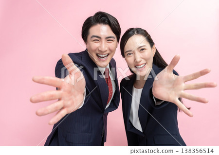 Welcoming businessmen and women Welcoming businessmen and women 138356514