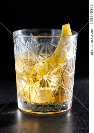 Rusty Nail Cocktail with Lemon Peel in Crystal Glass Rusty Nail Cocktail with Lemon Peel in Crystal Glass 138356598