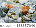 Relaxed spiritually child's hand arrangement pebble tower. Yoga relax meditation 138357040