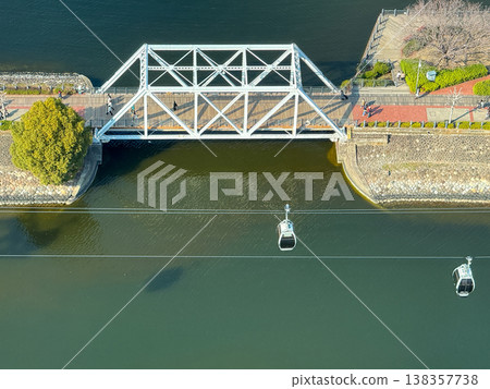 An aerial view of the ropeway crossing the canal in Yokohama Minato Mirai and the historic truss bridge. February 18, 2026, Yokohama City, Kanagawa Prefecture. An aerial view of the ropeway crossing the canal in Yokohama Minato Mirai and the historic truss bridge. February 18, 2026, Yokohama City, Kanagawa Prefecture. 138357738