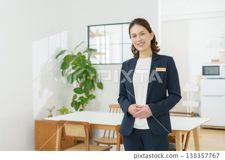 A middle-aged Japanese woman giving a tour of a housing exhibition. A middle-aged Japanese woman giving a tour of a housing exhibition. 138357767