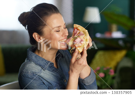 Woman Savoring Pizza with Eyes Closed 138357905