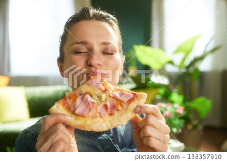 Playful Woman Savoring Her Favorite Pizza Snack 138357910