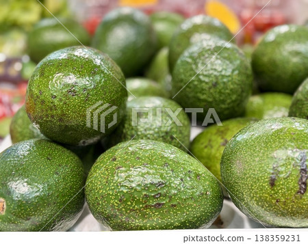 Large rifle green avocados harvested ready to eat are sold on supermarket shelves top view. Healthy eating. Close-up. 138359231