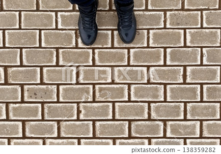 A beautifully textured brick pattern design is perfect for enhancing stylish architecture and interior decorations. Black men's shoes on the background. 138359282