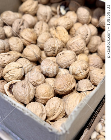 Large whole walnuts in large quantities in a basket on the market for sale. Healthy eating. Close-up. Large whole walnuts in large quantities in a basket on the market for sale. Healthy eating. Close-up. 138359333