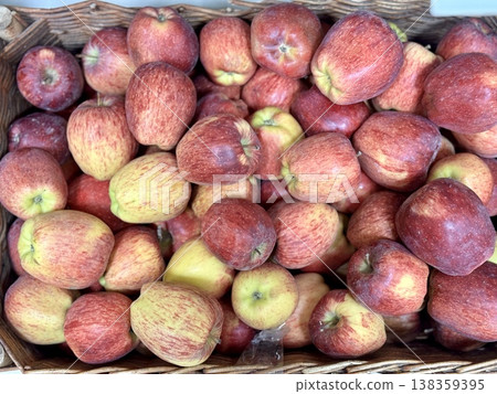 A vibrant and colorful display of fresh, crisp red apples organized neatly in a bustling market settings. Close-up. 138359395