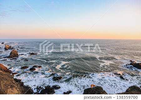 A red fox and coastline at Cape Erimo, illuminated by the setting sun. A red fox and coastline at Cape Erimo, illuminated by the setting sun. 138359700