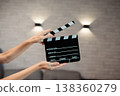 Hands holding clapperboard, signaling start of film production, cinematic movie making storytelling, industry concept 138360279