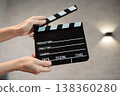Hands holding clapperboard, signaling start of film production, cinematic movie making storytelling, industry concept 138360280