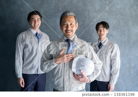 Japanese men smiling, lined up against a gray background. Japanese men smiling, lined up against a gray background. 138361196