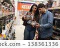 Couple comparing kitchen pots in a retail store for household items 138361336