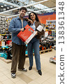 Young couple smiling, holding a power tool box at a hardware store 138361348