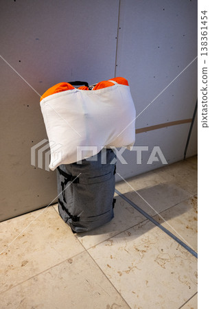 Travel backpack with packed bedding and pillow ready for trip minimal gear preparation concept Travel backpack with packed bedding and pillow ready for trip minimal gear preparation concept 138361454