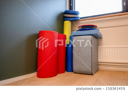Colorful fitness equipment set with yoga mat foam roller balance pad and exercise tools in modern workout space Colorful fitness equipment set with yoga mat foam roller balance pad and exercise tools in modern workout space 138361459
