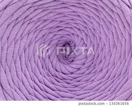Textured cotton tape background, rows of yarn for knitting forming geometric patterns and curves. Textured cotton tape background, rows of yarn for knitting forming geometric patterns and curves. 138361656