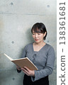 A woman holding a notebook 138361681