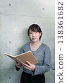 A woman holding a notebook 138361682