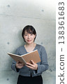 A woman holding a notebook 138361683