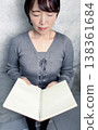 A woman holding a notebook 138361684