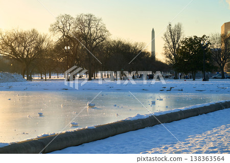 Capitol Reflecting Pool frozen in winter with Washington Monument obelisk at the background Capitol Reflecting Pool frozen in winter with Washington Monument obelisk at the background 138363564