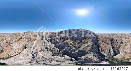 Majestic panorama of rocky mountains under clear blue sky, aerial view of arid mountain landscape and canyons on a sunny day 360 138363567