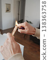 a man ignites a sandalwood incense stick 138363758