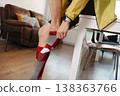a man pulls up a compression sock at home 138363766