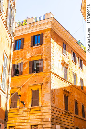 Orange house facade. Old building architecture in the city center Italy, Rome. Italian balcony windows. Orange house facade. Old building architecture in the city center Italy, Rome. Italian balcony windows. 138364068