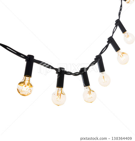 String Lights Hang Above a White Background Creating a Warm Glow in a Casual Setting During Evening Hours 138364409