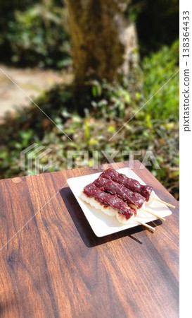 Enjoying springtime Japanese sweets, such as anko dango (sweet bean paste dumplings), outdoors in the warm sunshine. Enjoying springtime Japanese sweets, such as anko dango (sweet bean paste dumplings), outdoors in the warm sunshine. 138364433