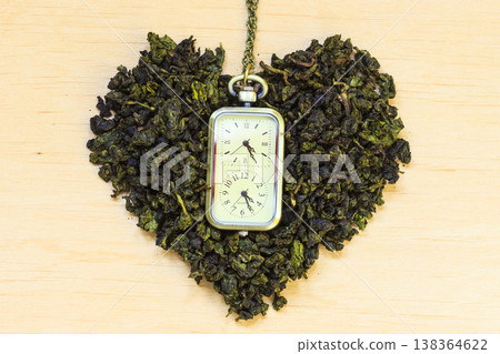 Green tea leaves heart shaped and watch Green tea leaves heart shaped and watch 138364622
