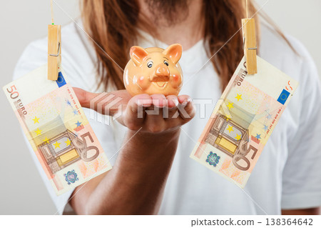 Man holding moneybox piggybank 138364642