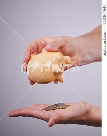 Male hands with coins and piggybank 138364643