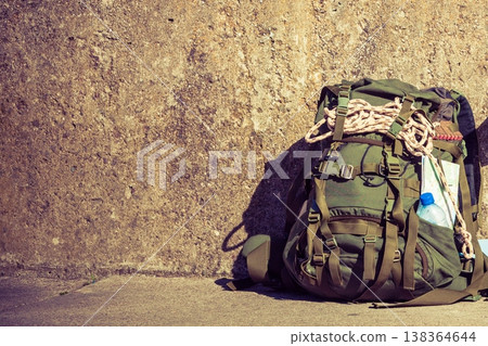 Hiking backpack camping equipment outdoor on grunge wall 138364644