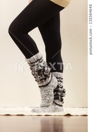 Woman legs wearing woolen socks and black tights Woman legs wearing woolen socks and black tights 138364648