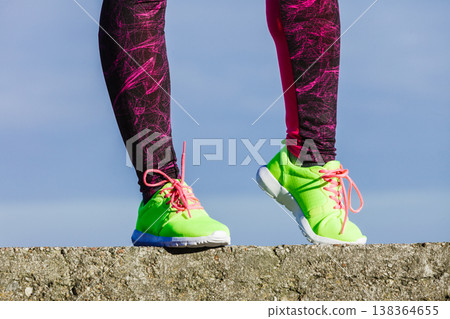 Female legs feet in vivid color yellow shoes on seaside. Female legs feet in vivid color yellow shoes on seaside. 138364655