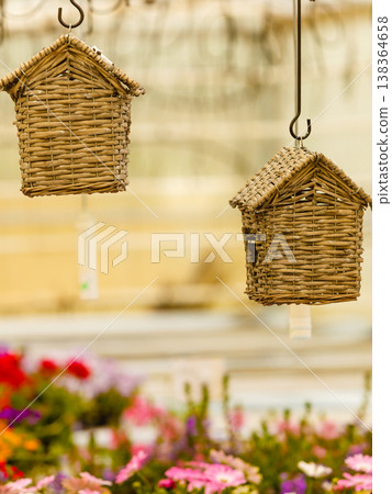 Hanging under ceiling wicker houses for birds 138364658