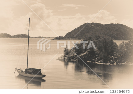 Beautiful idyllic lake landscape, swimming drifting yacht Beautiful idyllic lake landscape, swimming drifting yacht 138364675