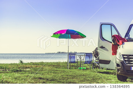 Umbrella with chairs at campervan on beach Umbrella with chairs at campervan on beach 138364895
