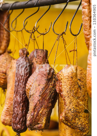 Smoked sausages meat hanging in smokehouse Smoked sausages meat hanging in smokehouse 138364905