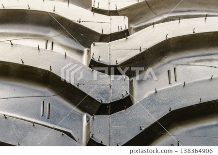 Detailed closeup of rubber tire wheel surface. 138364906