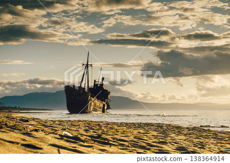 Rusty broken shipwreck on sea shore Rusty broken shipwreck on sea shore 138364914