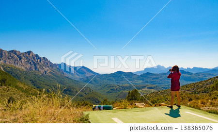 Woman take photo in mountains Woman take photo in mountains 138365076
