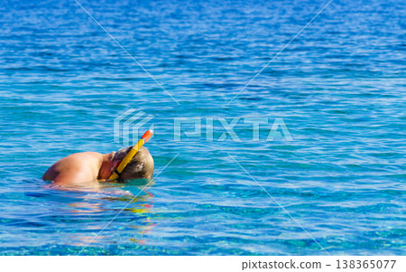 Man with snorkeling tube in sea Man with snorkeling tube in sea 138365077